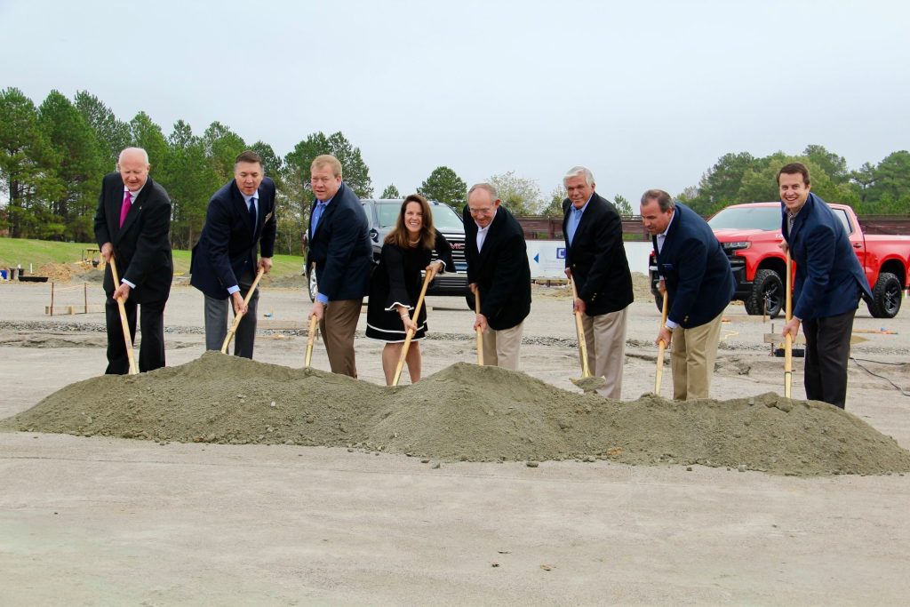 Group of people breaking ground