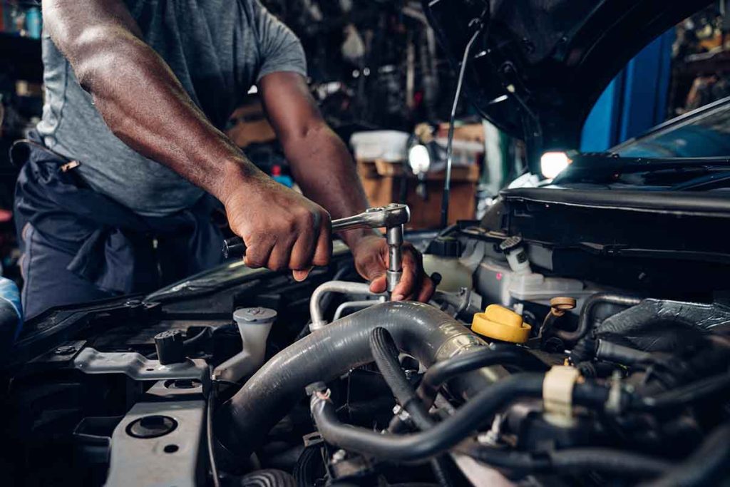 Auto mechanic are repair and maintenance auto engine is problems at car repair shop.